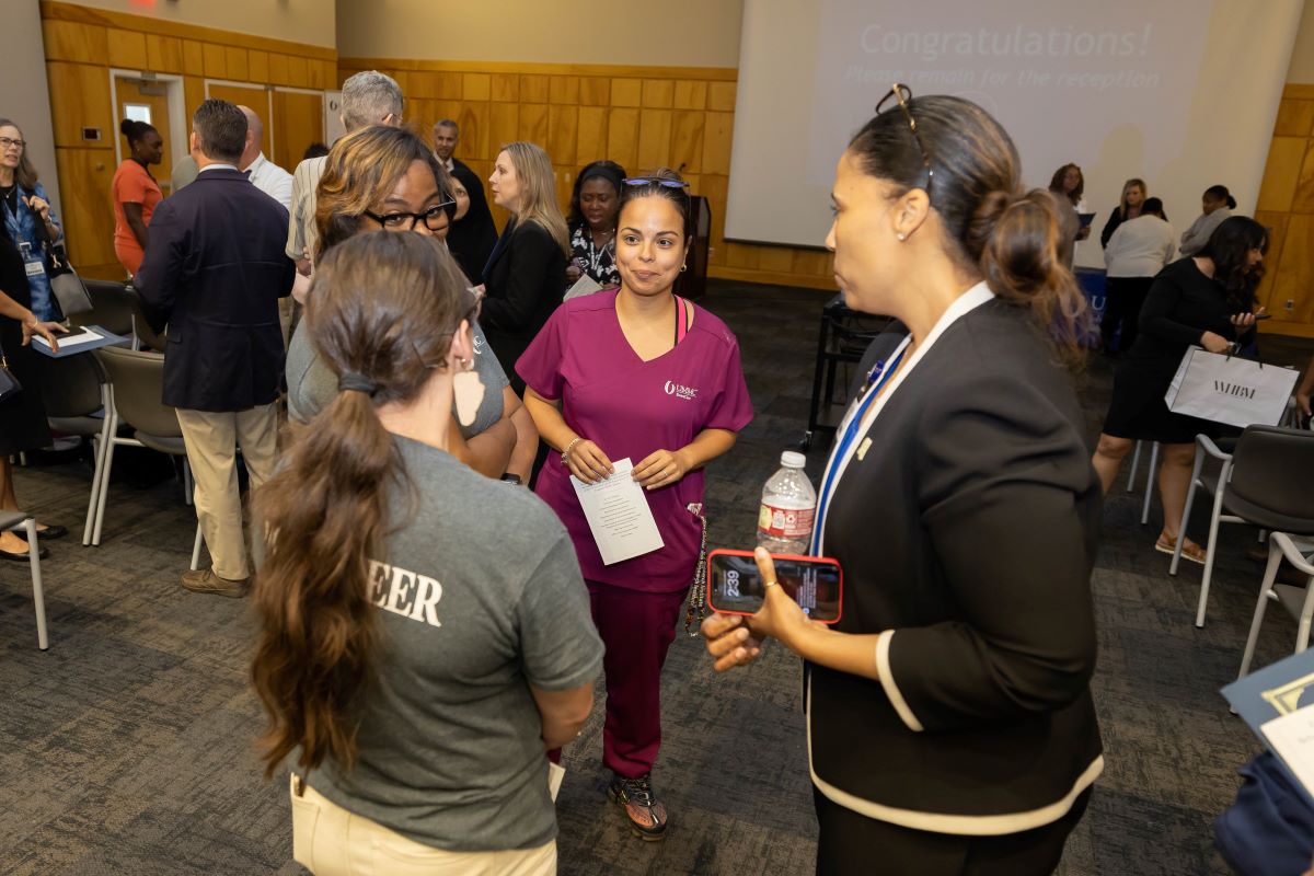 People standing around talking at the 2023 Honors and Awards Ceremony